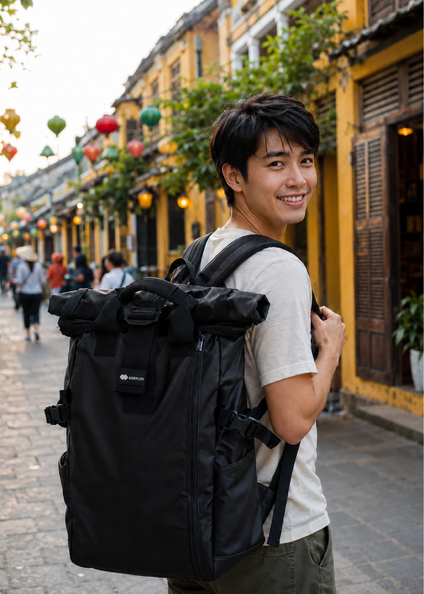 A traveler wearing a backpack with a esim.vn sticker.
