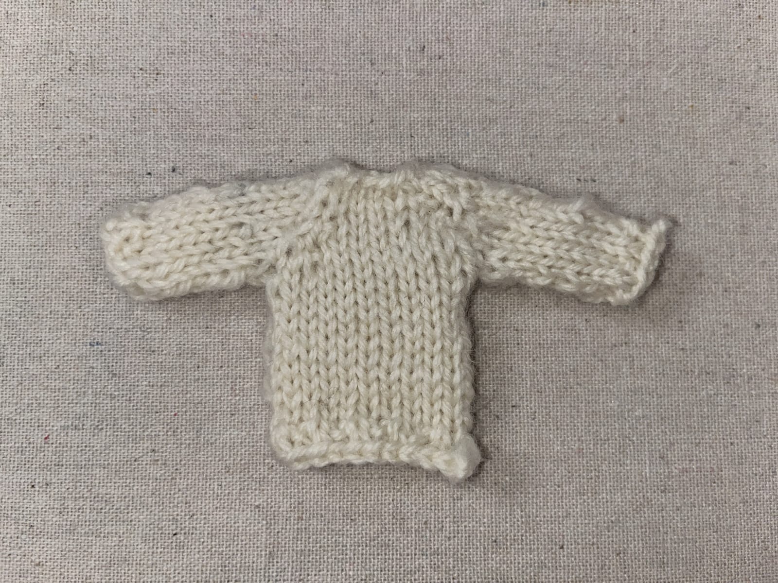 Mini knitted sweater before felting