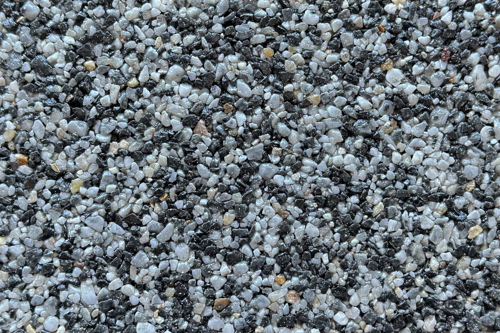 A close-up view of gray and black stone vuba aggregate texture suitable for resin-bound flooring applications.