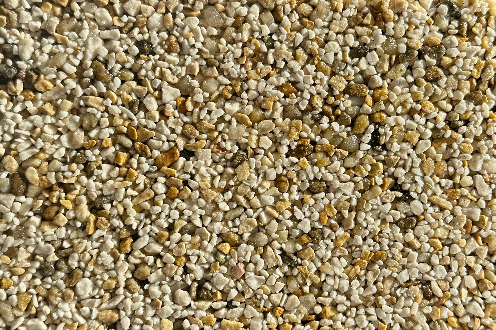 A close-up view of gold and beige vuba stone aggregate texture suitable for resin-bound flooring applications.