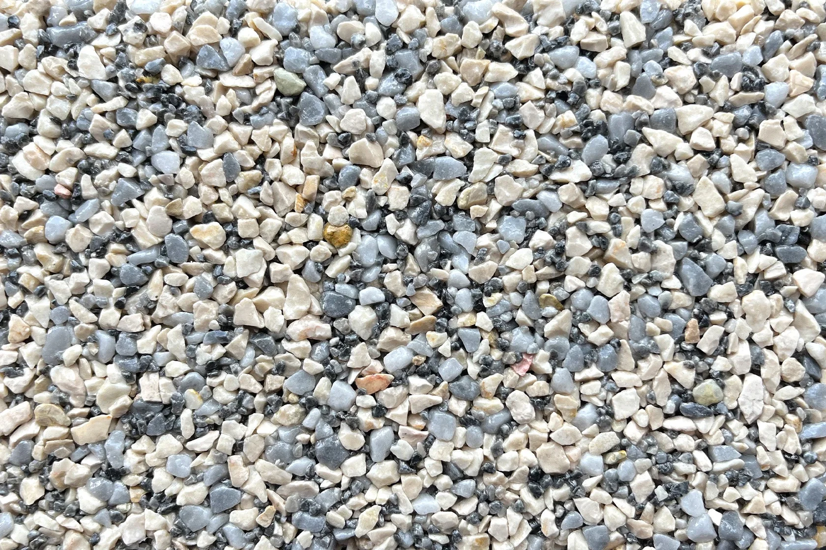A close-up view of gray and beige stone aggregate, ideal for resin-bound flooring applications.