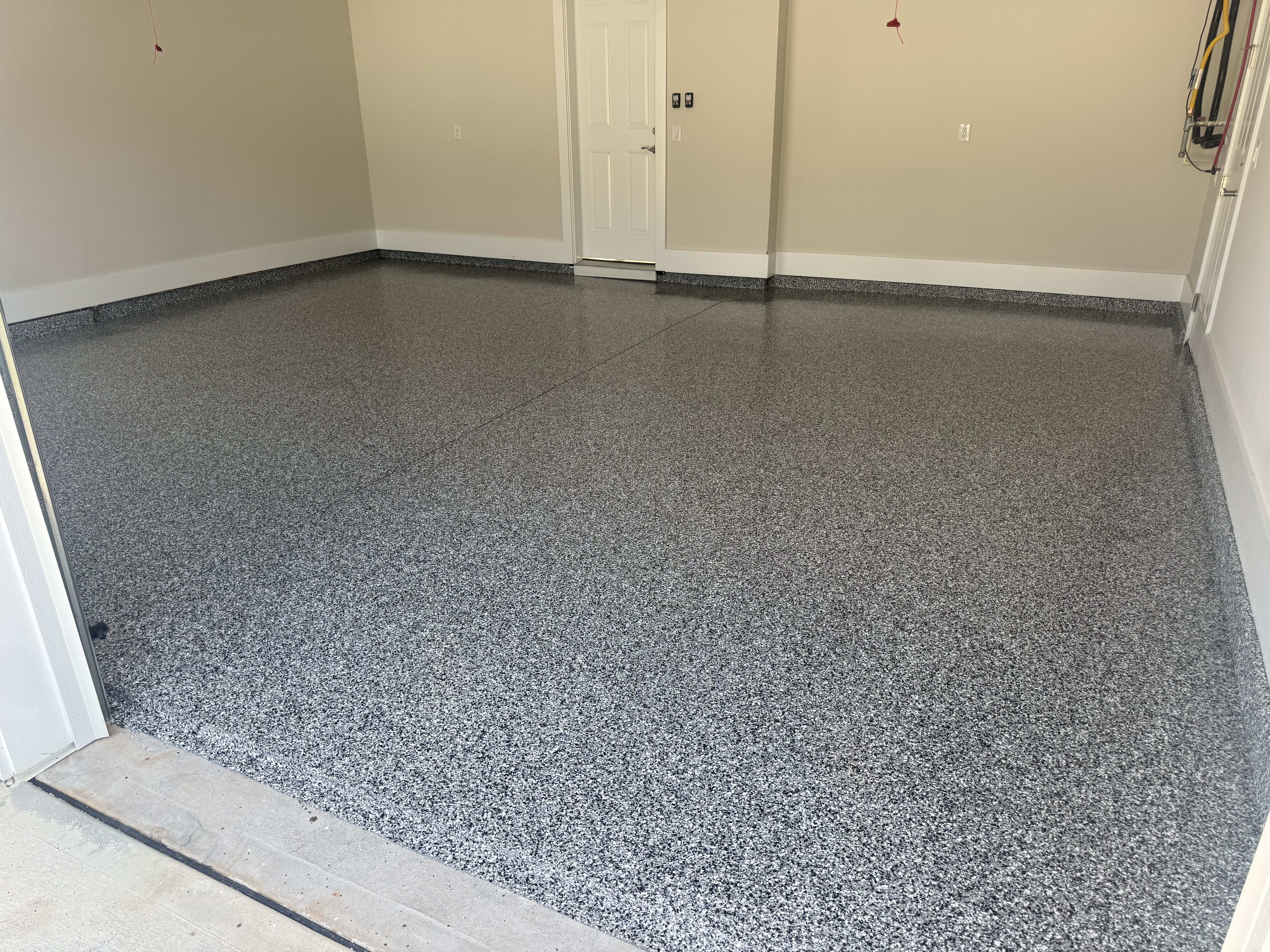 A sleek, polished garage floor showcasing a durable polyaspartic coating for enhanced aesthetics.