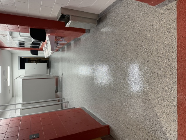 Polished polyaspartic floor in a commercial bathroom.
