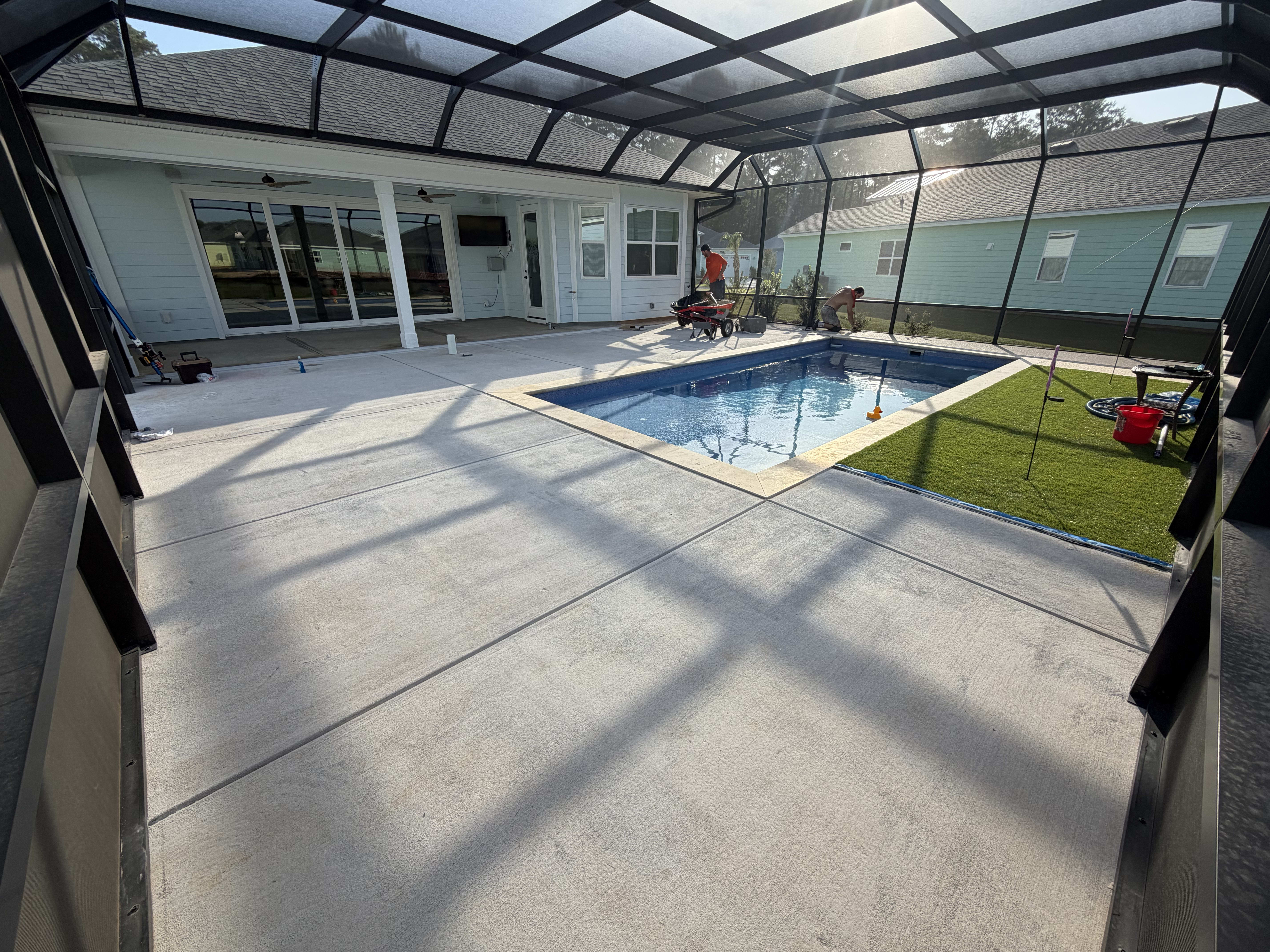 Screened pool enclosure with concrete deck
