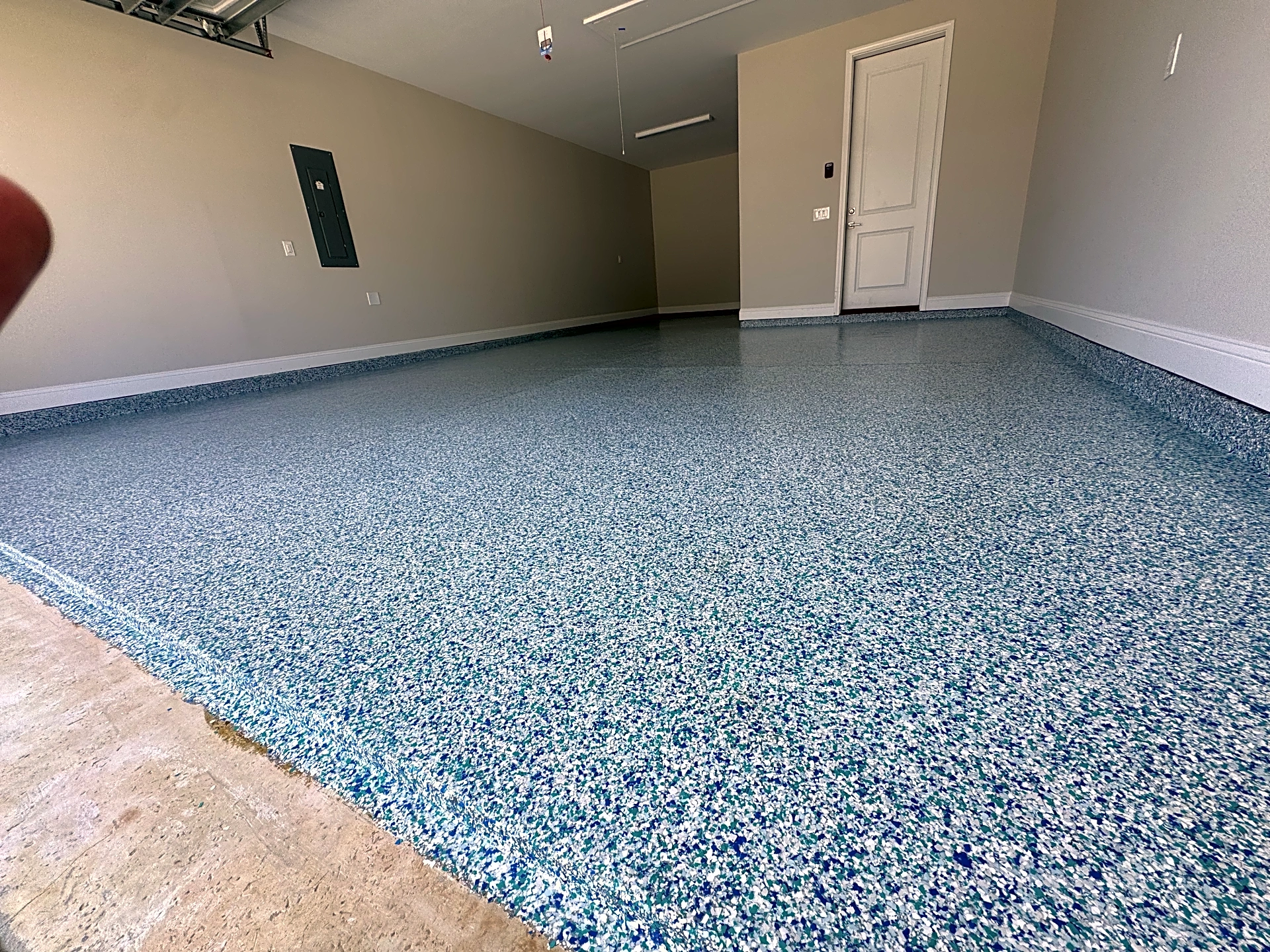Close-up view of textured blue vinyl flake garage floor coating in Bluffton, SC.