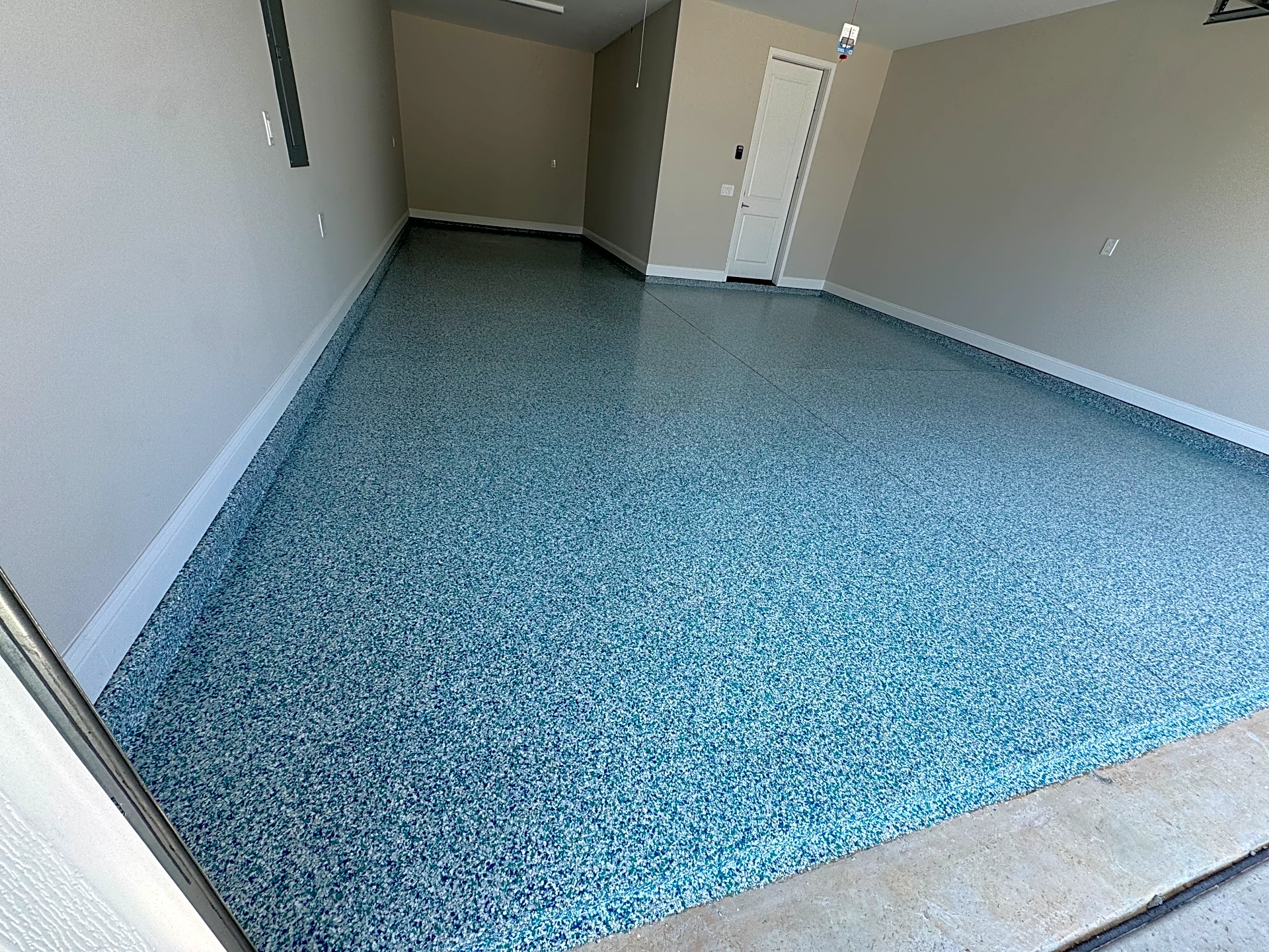 A newly applied polyaspartic garage floor coating showcasing a smooth, colorful finish in Lowcountry.
