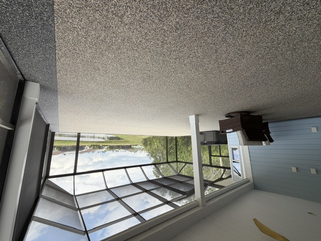 A textured concrete floor in a screened patio overlooking a serene outdoor view in South Carolina.