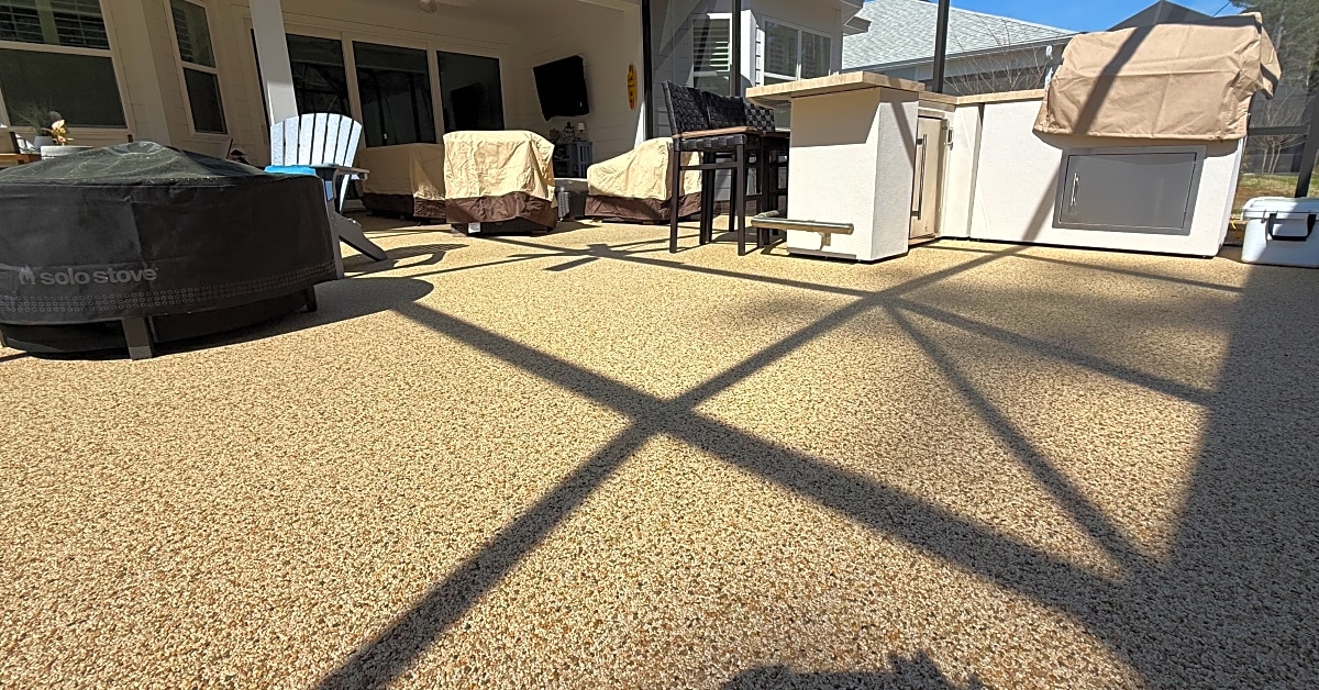 A textured concrete floor in a screened patio with seating and a bar area in South Carolina.