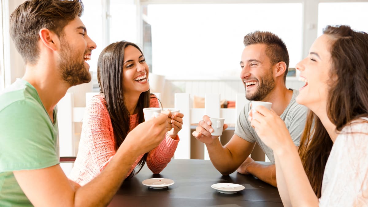 friends happily drinking coffee together