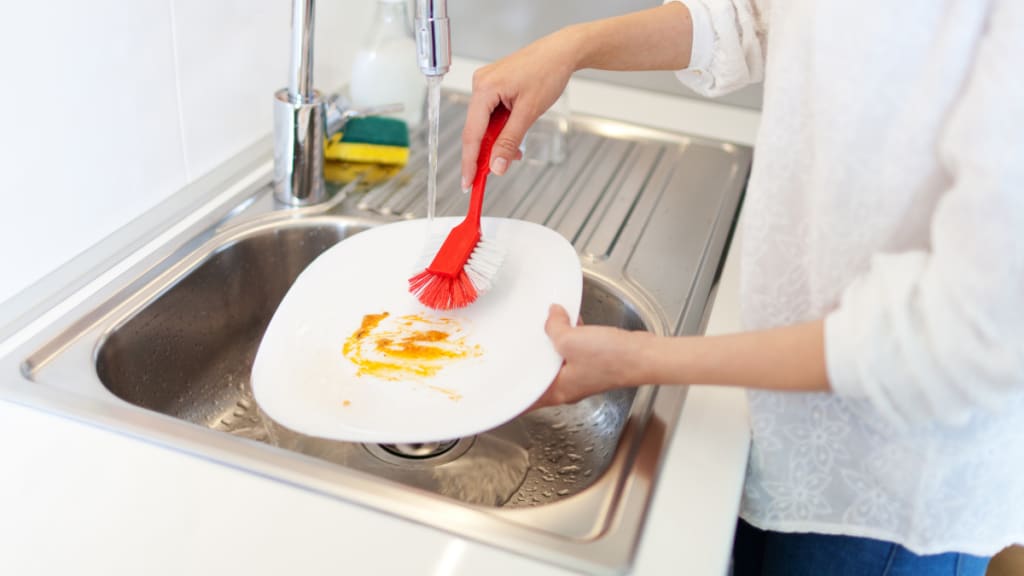 washing dirty dishes in the sink