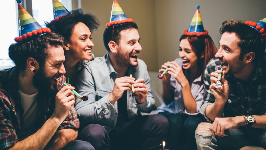 friends with party hats celebrating birthday