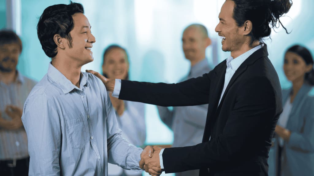 Manager Giving Employee a Pat on the Shoulder