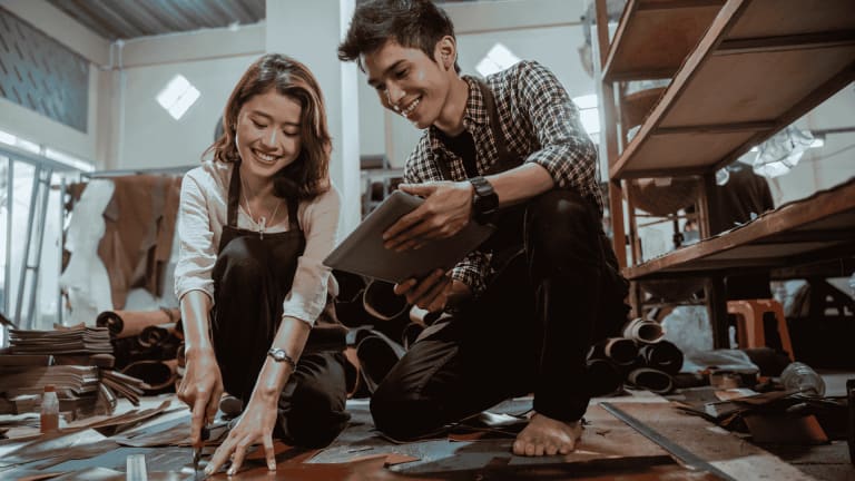 Couple working on leather crafting
