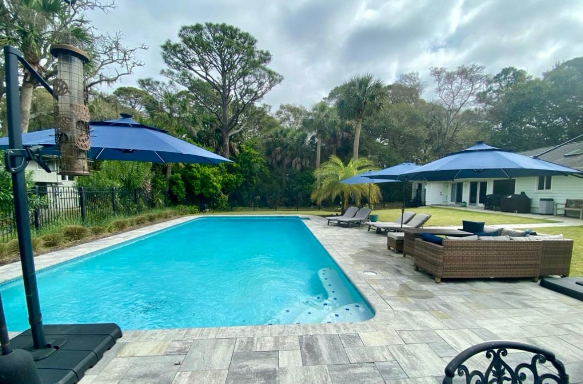 Enjoy your day around this large pool with lounge and patio furniture