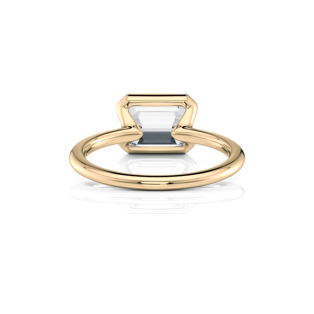 18k yellow gold e.w. half bezel emerald solitaire engagement ring with emerald shape diamond