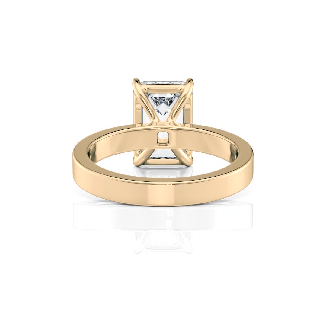 18k yellow gold solitaire cigar band with emerald shape diamond