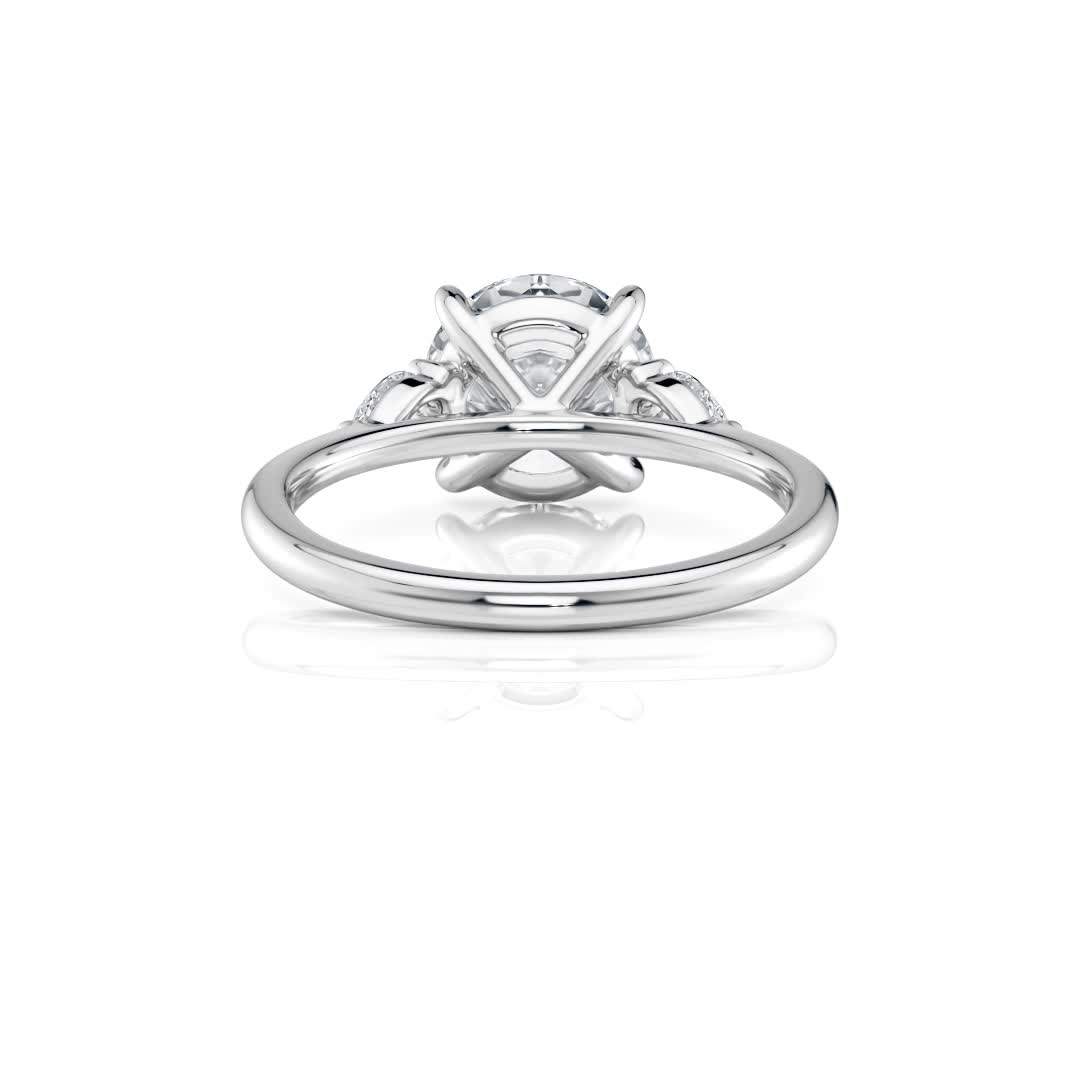 platinum three stone pear lab diamond engagement ring-sits flush with a wedding band with round shape diamond