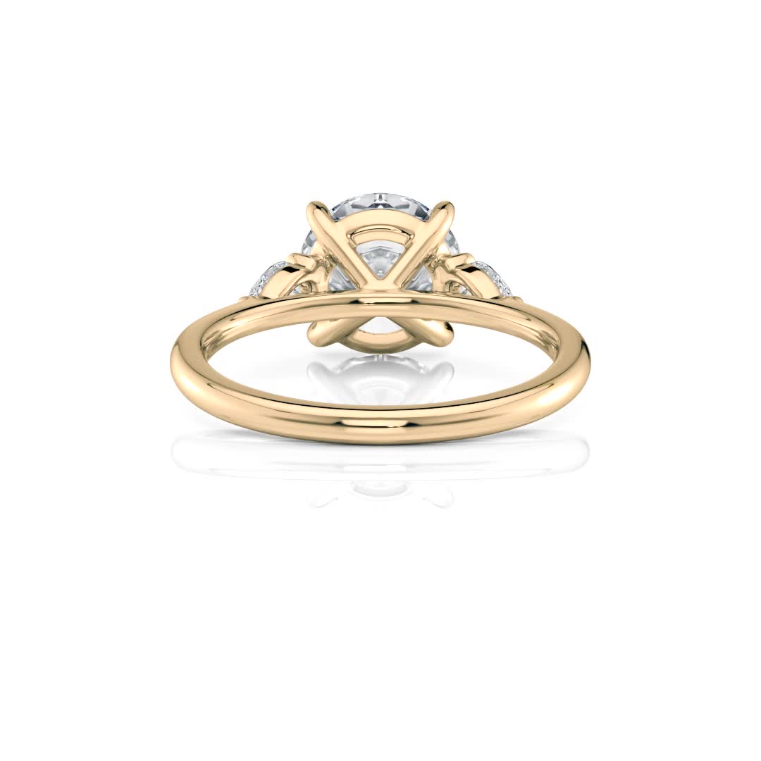14k yellow gold three stone pear lab diamond engagement ring-sits flush with a wedding band with round shape diamond