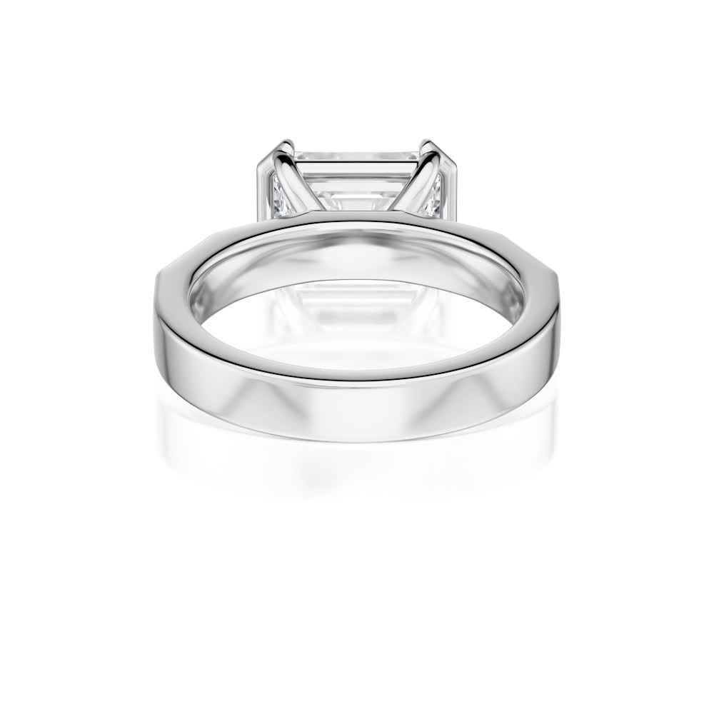 18k white gold e.w. geometric half bezel emerald solitaire engagement ring with emerald shape diamond