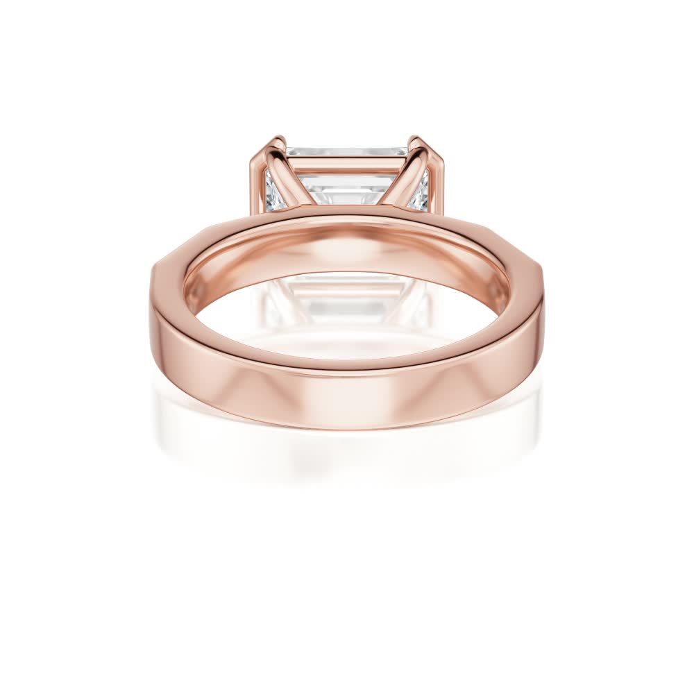 14k rose gold e.w. geometric half bezel emerald solitaire engagement ring with emerald shape diamond