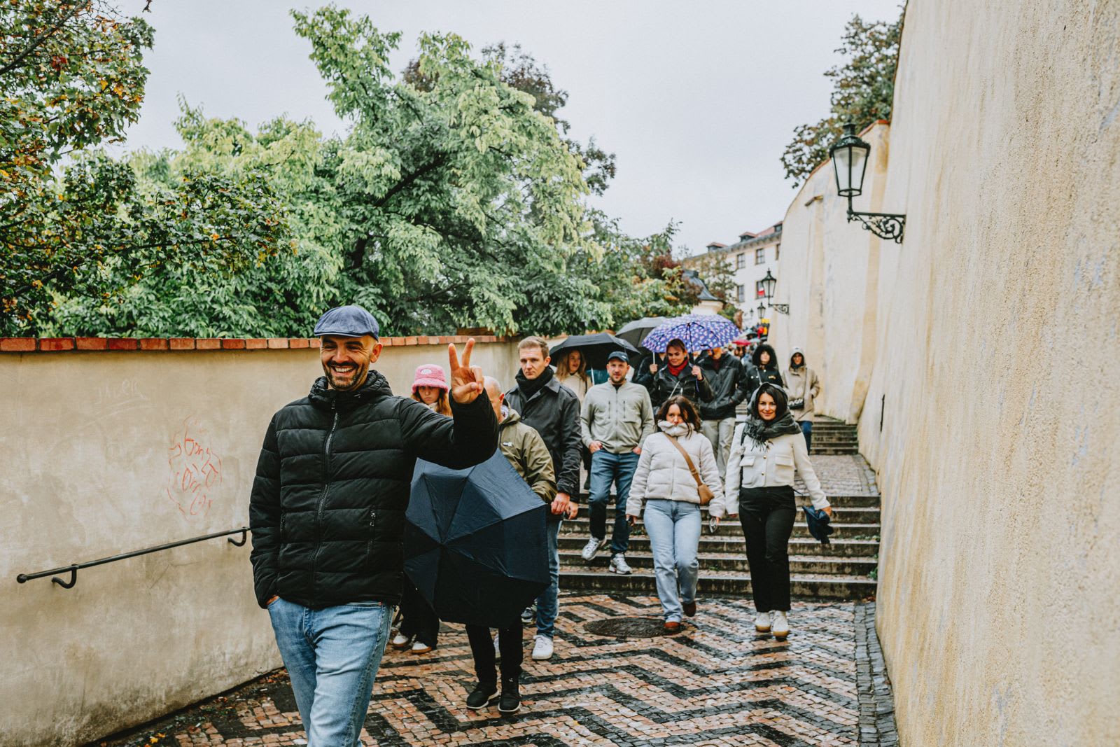 Group of travellers walking down a historic cobbled street in a European old town