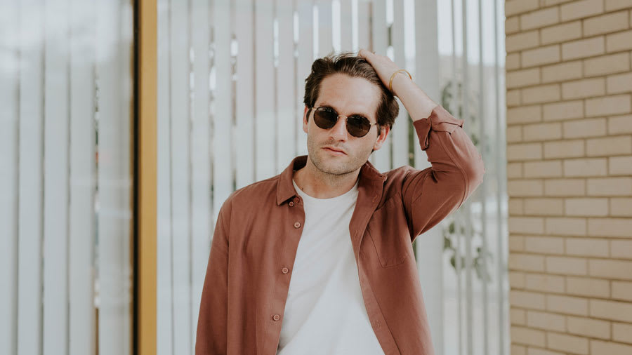 man wearing sunglasses scratching scalp psoriasis
