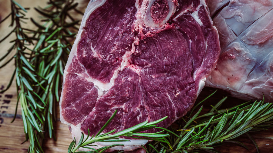Beef with rosemary garnish on a table