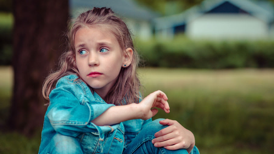 Girl in denim playing outdoors