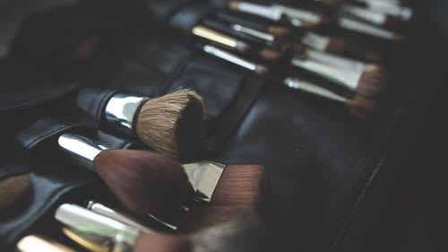 Makeup brushes lined up in a row