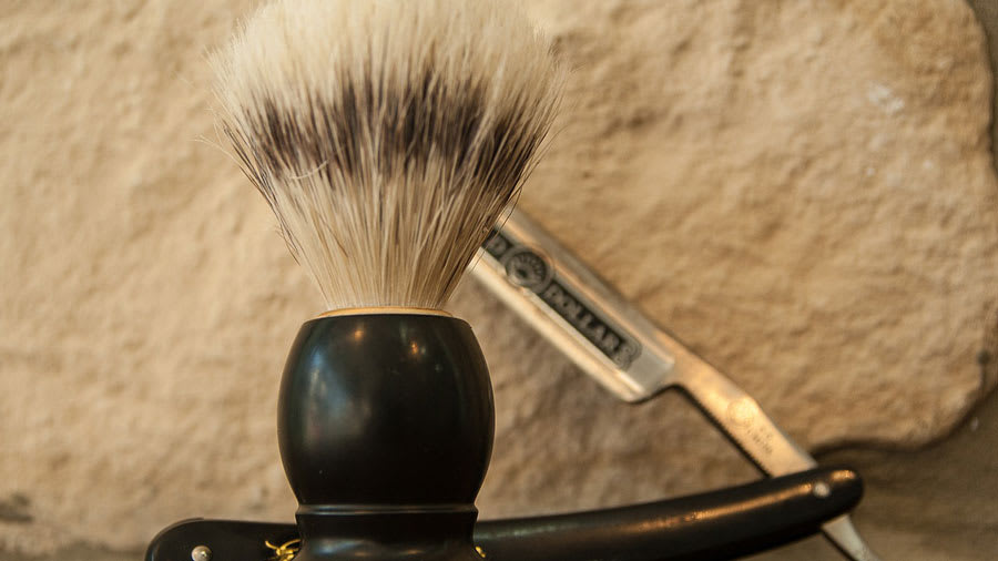 Shaving razor and brush on a table