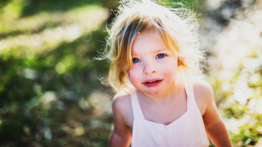 Child playing outdoors with psoriasis