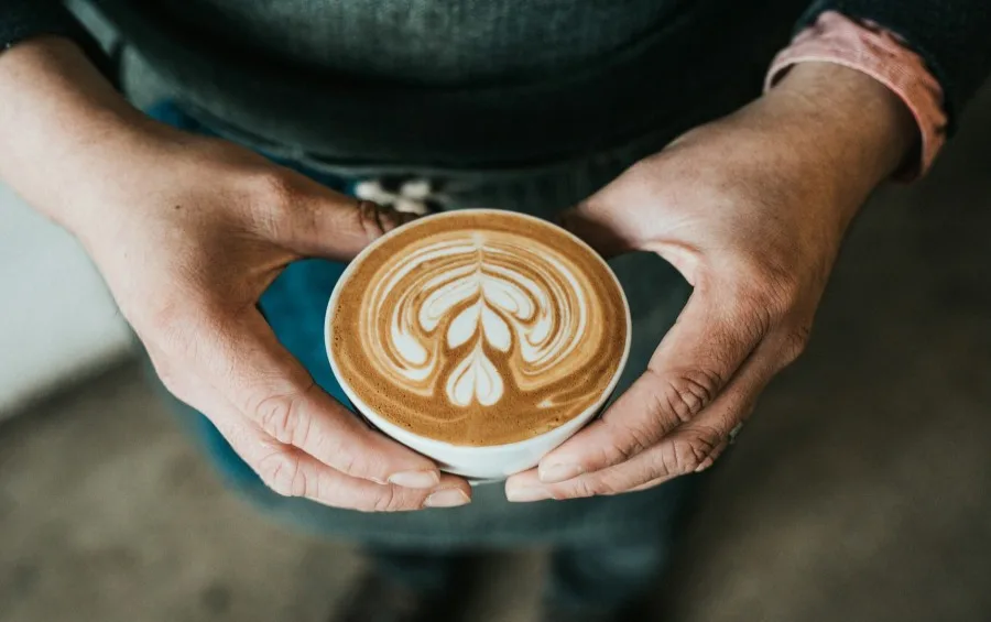 Person Holding a Latte