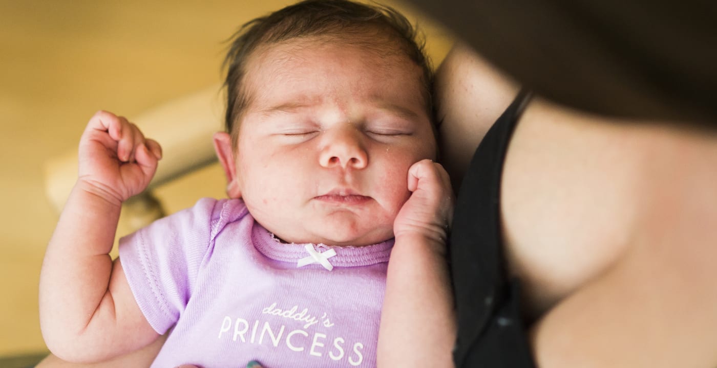 Mother holding sleeping baby