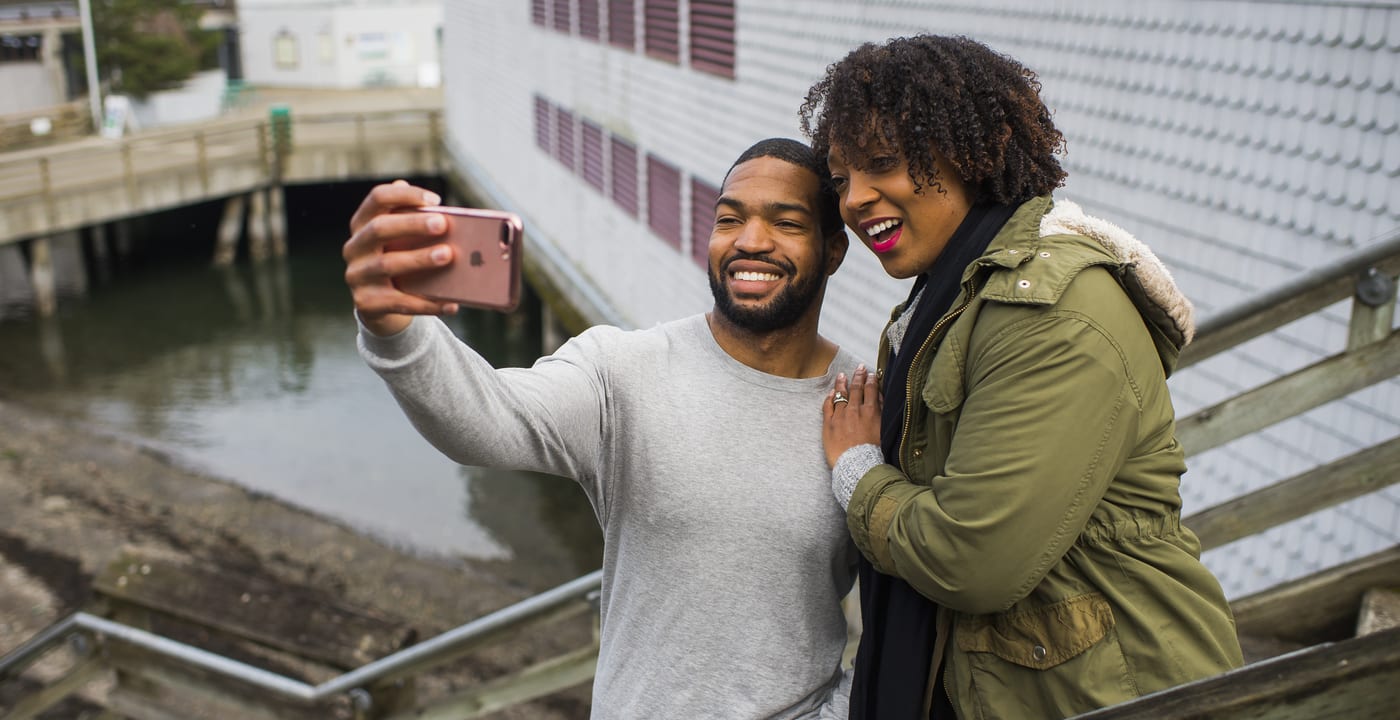 Man and woman smiling and taking a picture