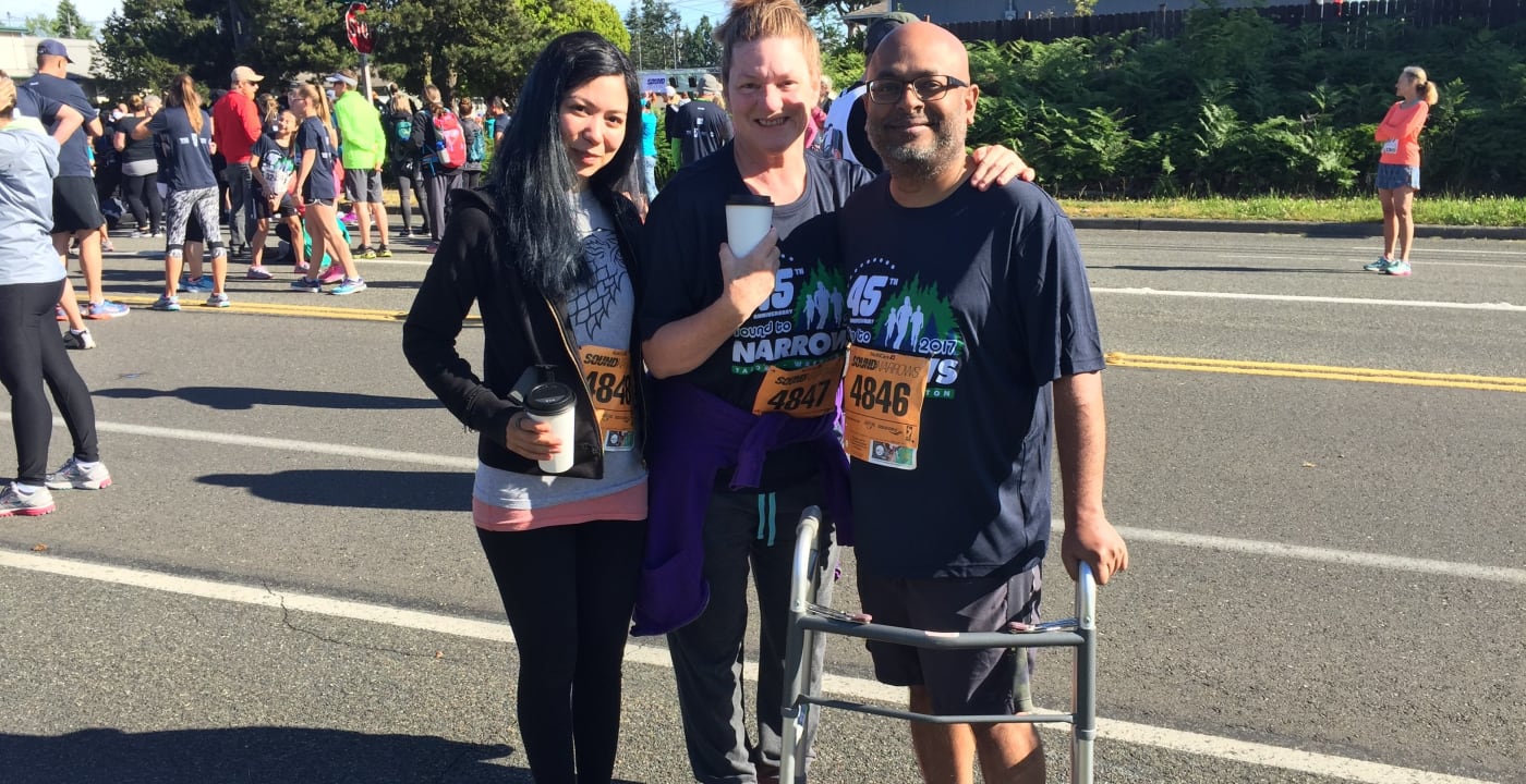 Three runners stand in the street after completing the Sound to Narrows race.