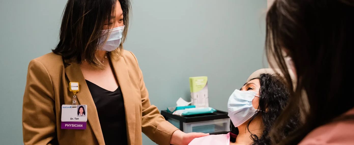 Doctor talking to patient in exam room