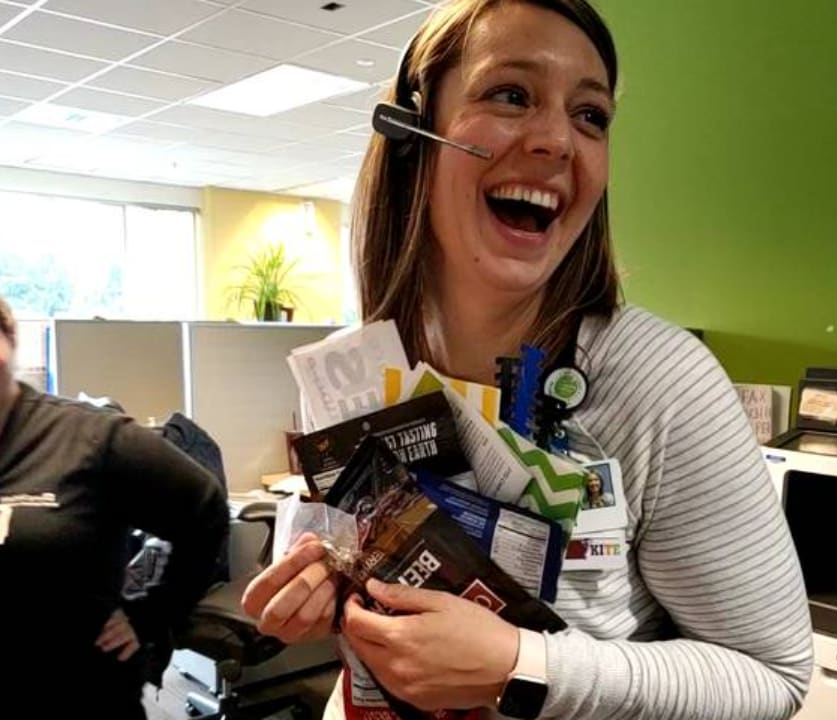 Woman laughing holding supplies