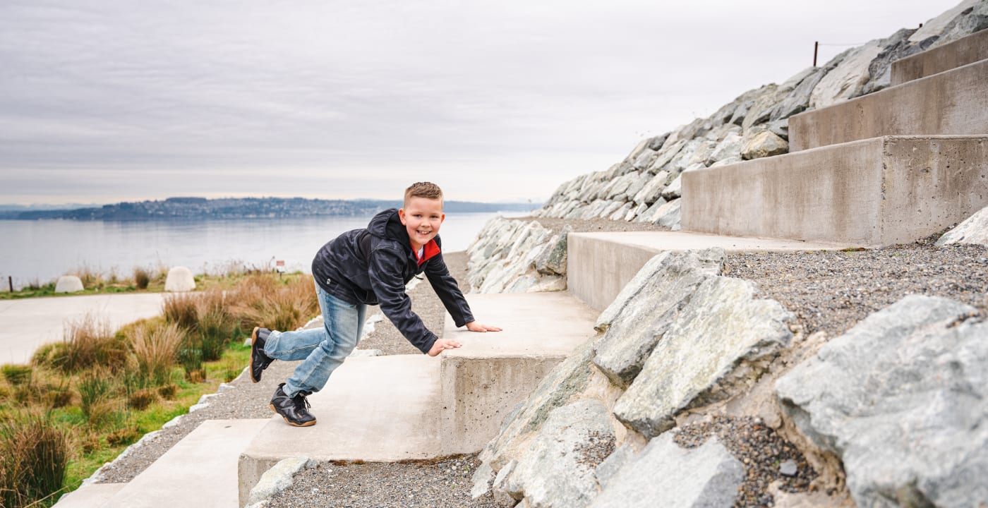 Young boy climbing rocks