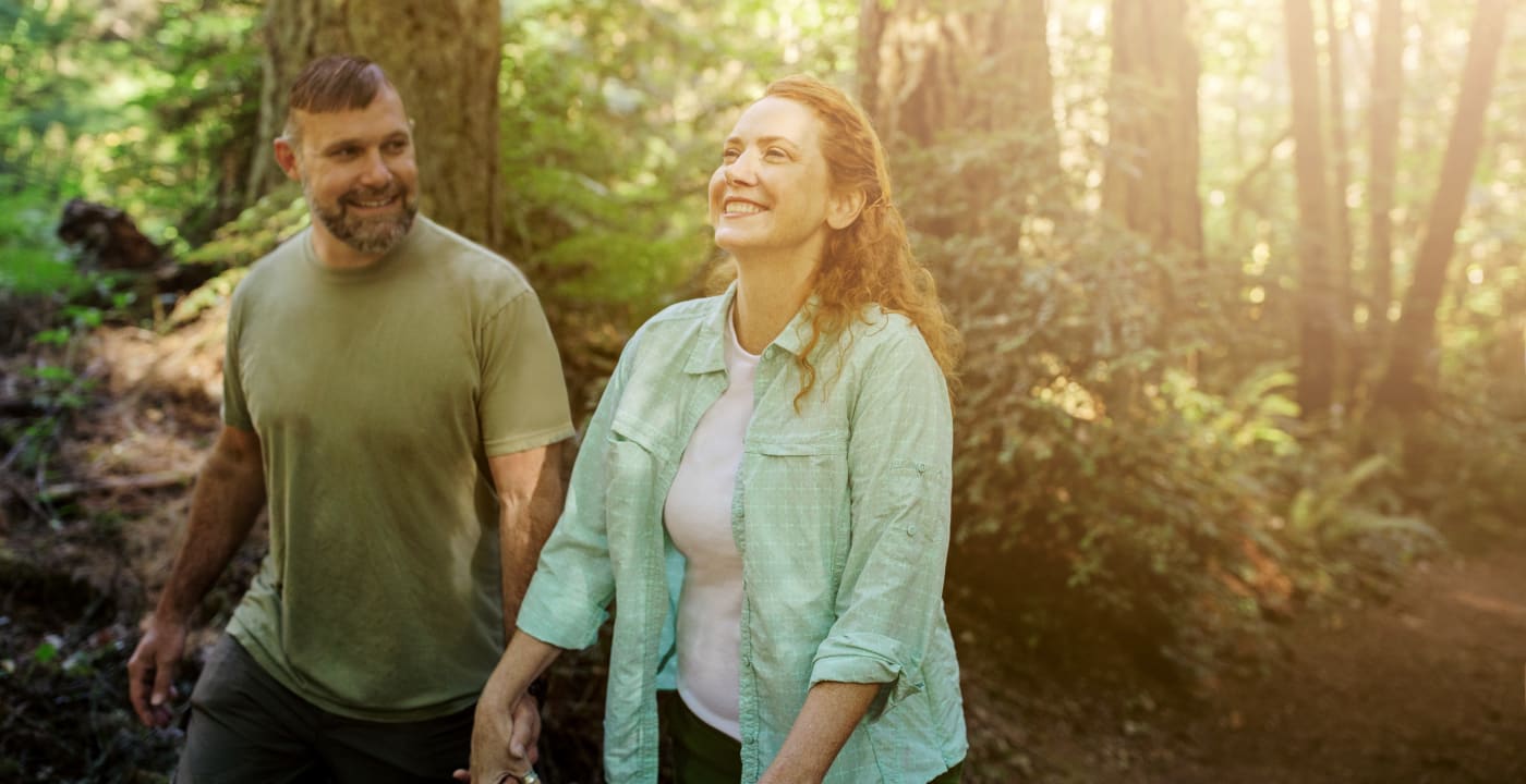 Couple walking through forest