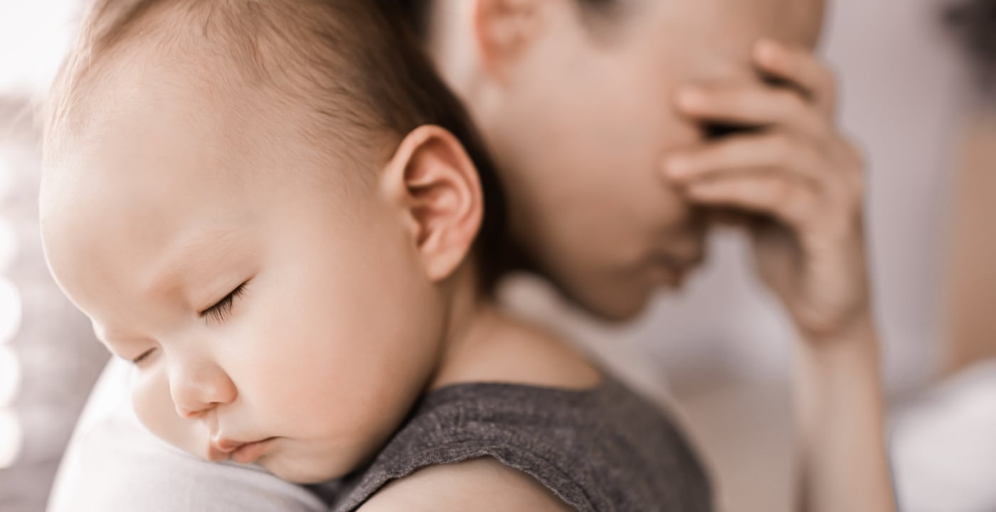 Tired mom holding baby