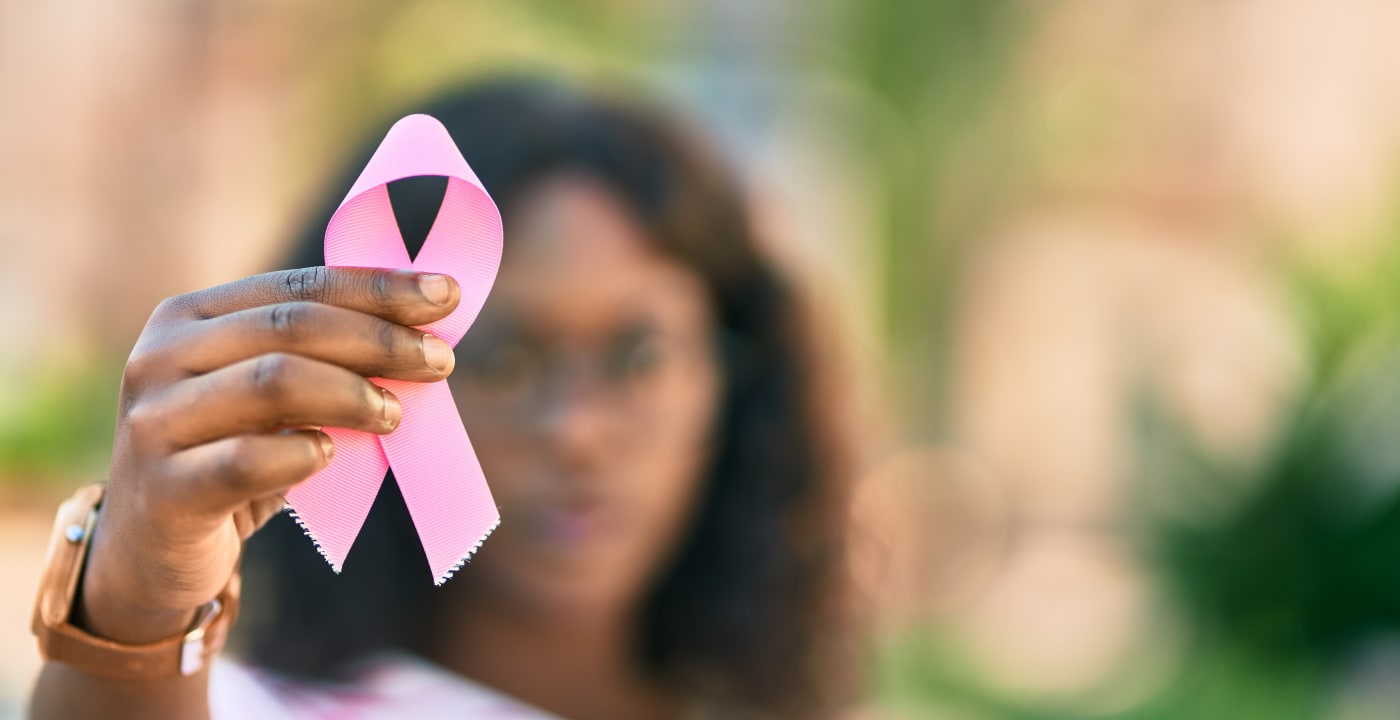 Woman holding a pink ribbon