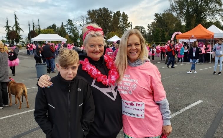 Two women and a child participating in a walking event