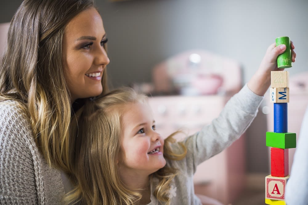 Mom and daughter smiling