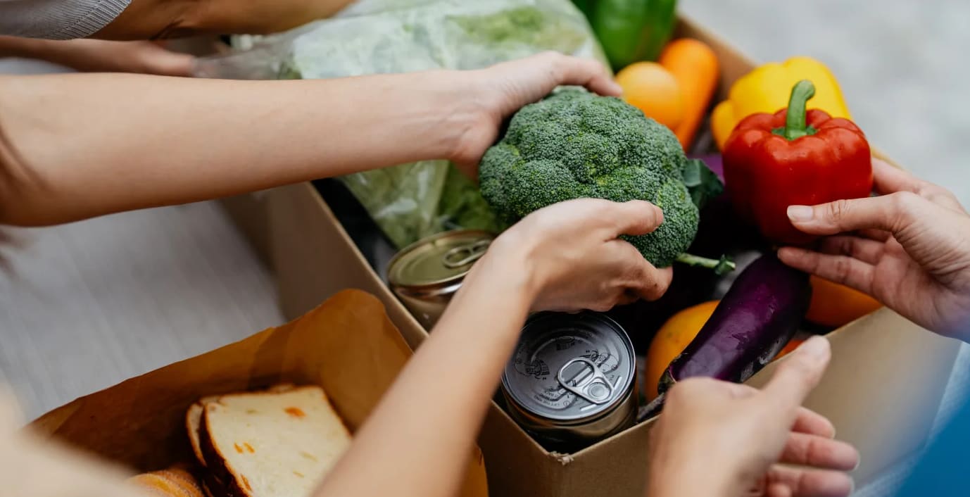 Hands unloading a grocery bag.