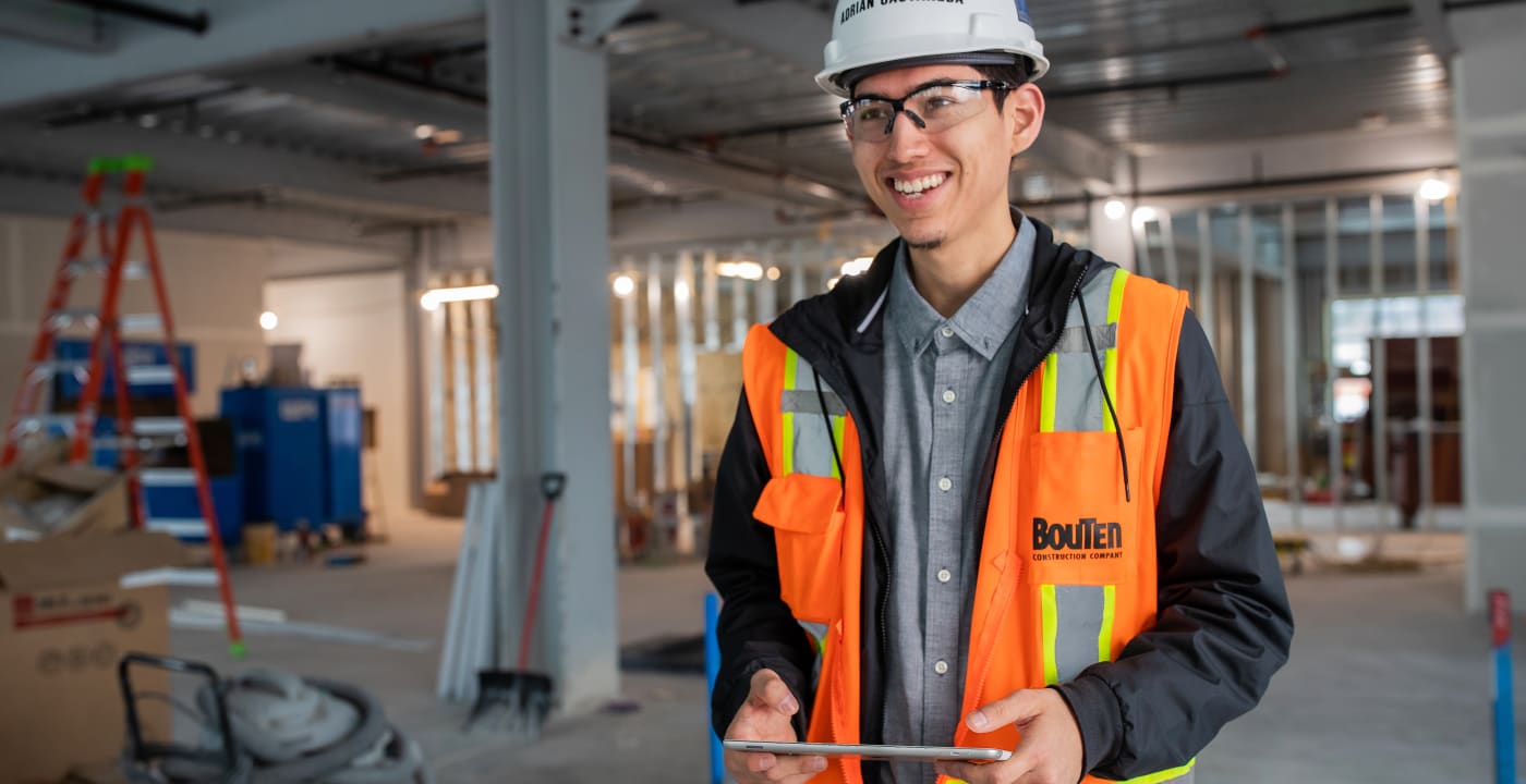 Safety worker in orange work vest and hardhat