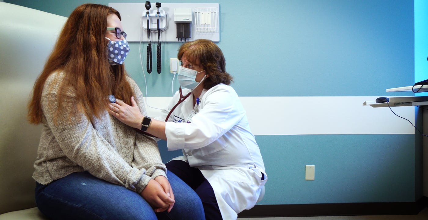 Doctor listening to a teenagers heart beat