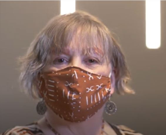 Woman with a mask on looking at the camera