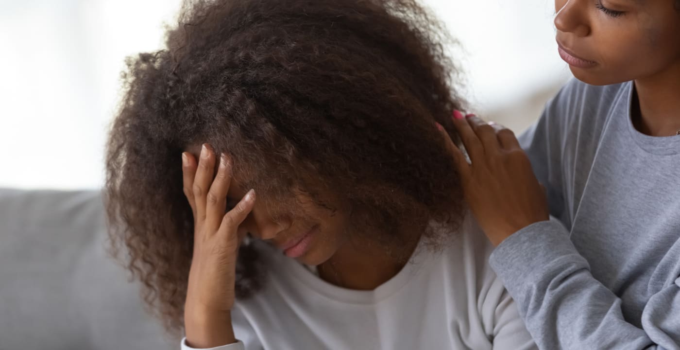 Mother comforting upset teen daughter