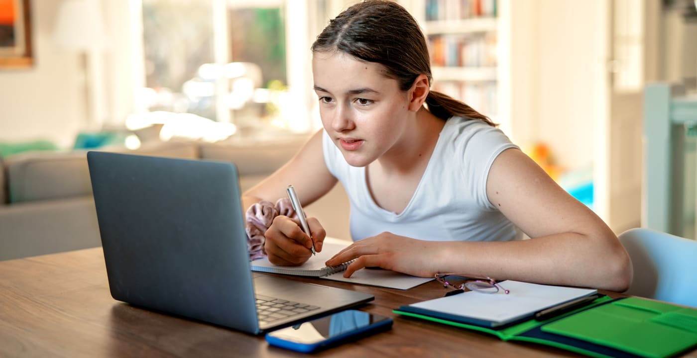 Teen girl studying on the computer