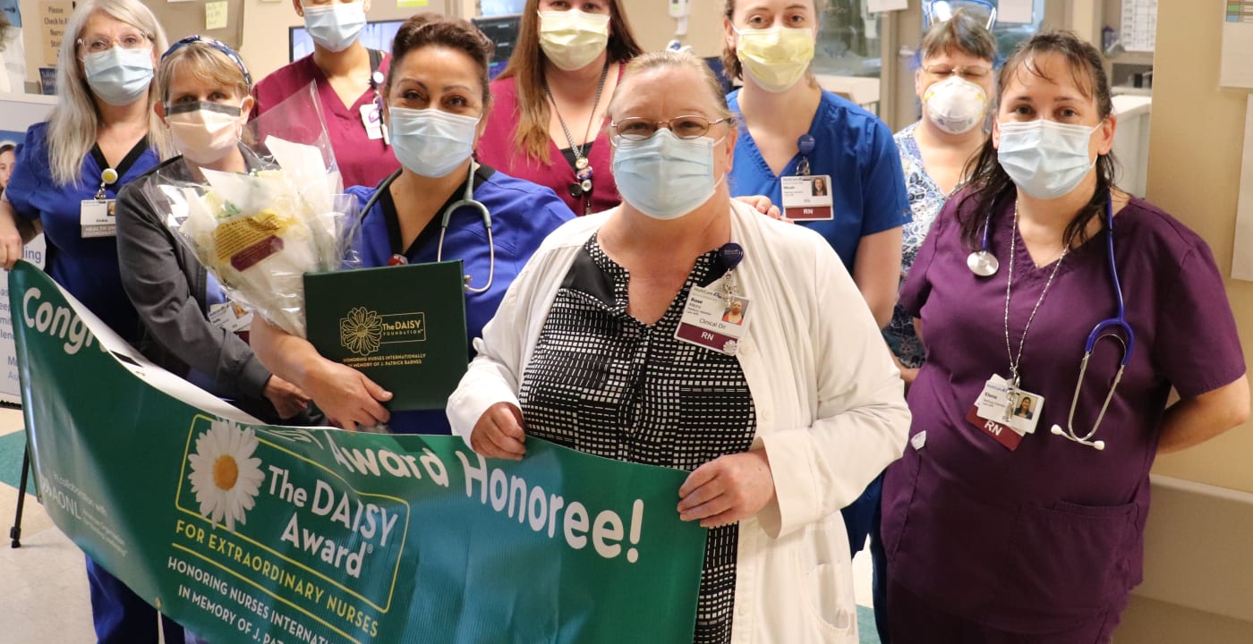 Nurses gathering with a banner